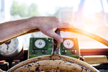 Hand on the old ship's wheel.
