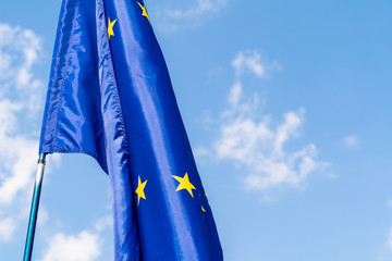 European Union flag against blue sky waving