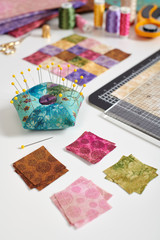 Square pieces of colorful bright fabrics for making quilt, pincushion, quilting block, sewing and quilting accessories