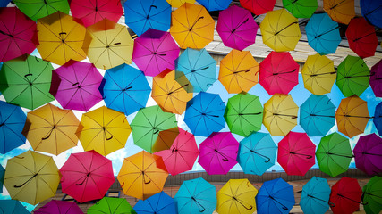 Fototapeta na wymiar Street decorated with colored umbrellas background