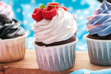 Side view of yummy cupcakes with assorted flavor. Shot on the table