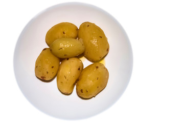 Boiled potatoes with butter on a white plate.