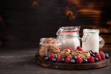 Homemade biscuits with bluebarries and fresh milk over a rustic wooden table