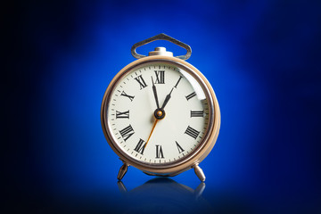 Alarm clock on blue background.