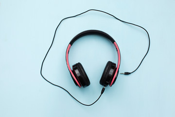 Headphones on blue background with free text space. Music concept.