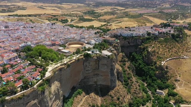 Aerial view of cityscape of Ronda, famous historic city and tourist attraction in Costa del Sol, corrida arena Bullring of the Royal Cavalry - landscape panorama of Andalusia from above, Spain, Europe