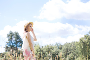 Young beautiful girl in the hat walking