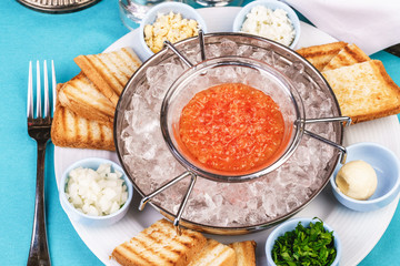 Mediterranean red caviar appetizer on ice, toast, butter, and a set of sauces