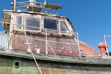 ancient Rusty Ship Board of old and colored boat wooden hull past used painting with cracks and...