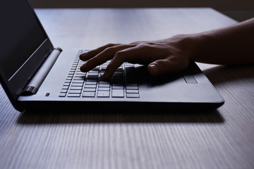 Laptop, a male hand using laptop on the desk 