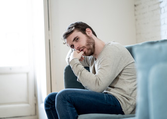 Fototapeta premium Young man suffering from depression hopeless and alone at home