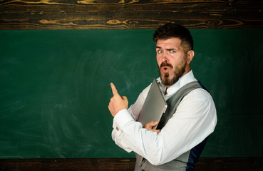 Teacher job. Preparing for exam in college. Learning concept. Bearded teacher near chalkboard in...