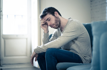 Fototapeta premium Young man suffering from depression hopeless and alone at home