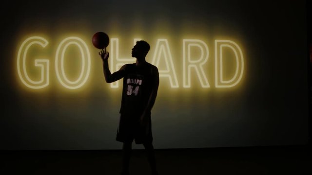 African American black basketball player posing against huge screen. Shot on ARRI Alexa Mini in 4K RAW