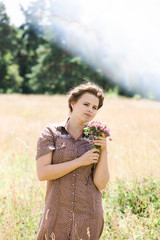 Young girl with a bouquet of clovers in the meadow, Photos with highlight