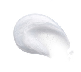 Pearly white smears and texture of face cream or acrylic paint isolated on white background