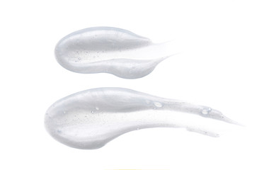 Pearly white smears and texture of face cream or acrylic paint isolated on white background