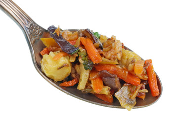In the old golden spoon there is a small pile of food - Chinese-style fast-fried vegetables isolated macro