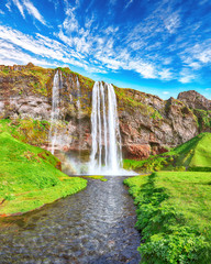 Fantastic Seljalandsfoss waterfall in Iceland during sunny day.