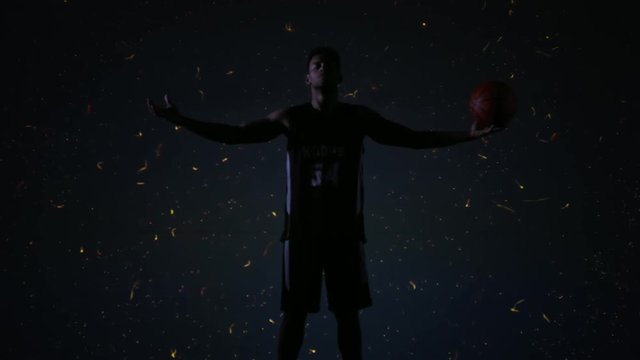 African American black basketball player posing against explosion animation on a huge screen. Shot on ARRI Alexa Mini in 4K RAW