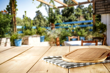 Wooden table of free space and summer restaurant background 