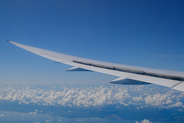 View of the wing of the aircraft and the clouds from the porthole