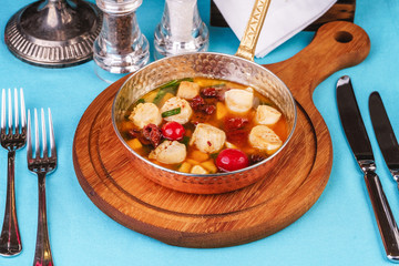 Italian fish soup with tomatoes, dough, dumplings, potatoes and greens. Mediterranean cuisine, European dish