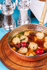 Italian fish soup with tomatoes, dough, dumplings, potatoes and greens. Mediterranean cuisine, European dish