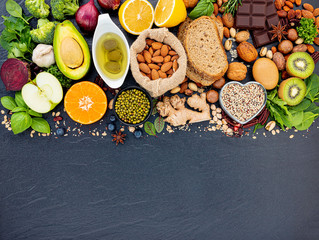 Ingredients for the healthy foods selection. The concept of healthy food set up on dark stone...