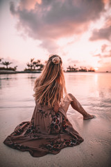 woman on beach during sunset in maldives - obrazy, fototapety, plakaty