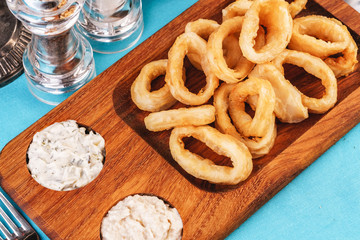 European cuisine, Mediterranean dish. Squid rings fried in batter snack for beer with cream sauce and steamed rice