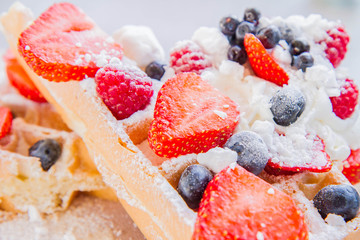 Waffle with whipped cream, fresh forest fruit and caster sugar