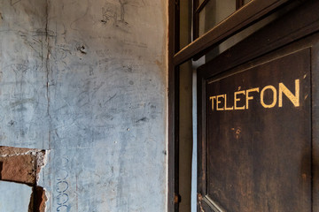 Telephone sign on the old door
