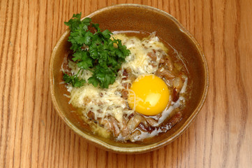 Japanese ramen soup with tofu and egg on wooden background. Miso soup with ramen noodles in ceramic bowl, asian traditional food.