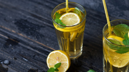 Summer cold homemade Mojito tea with mint and lemon and ice .