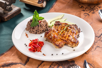 pork chop steak with steamed brown rice on old map background