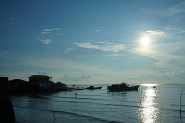 Naklejka na ściany i meble beautiful silhouette traditional fisherman boat at fishing settlement in bintan island 