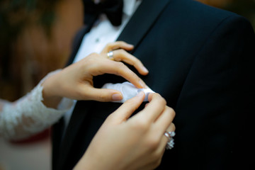 Fototapeta premium bride preparing groom for wedding