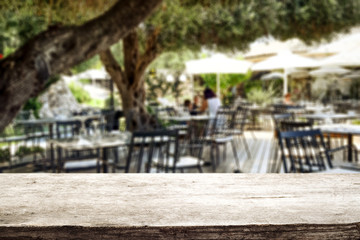 Wooden table of free space and summer restaurant background 