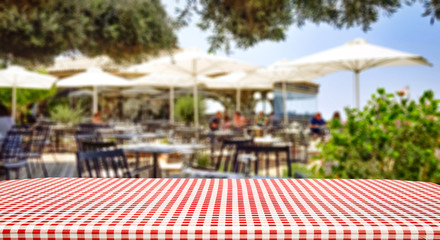 Wooden table of free space and summer restaurant background 