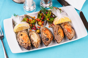 European cuisine, Mediterranean dish. Plate of assorted mussels and oysters cooked with spices i berries