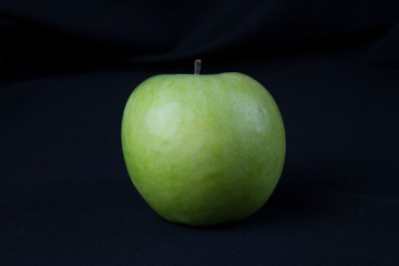 Green Apple on black background. Fruits. Healthy diet.