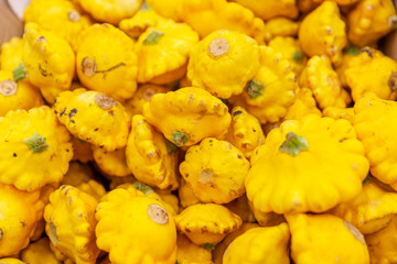 Yellow squash in a box in a supermarket. Close-up. Background. Space for text.