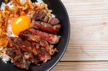 sliced beef on topped rice bowl with egg