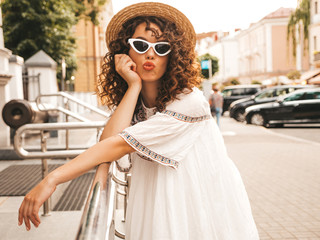 Beautiful smiling model with afro curls hairstyle dressed in summer hipster white dress.Sexy...