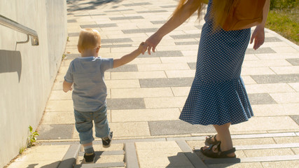 Mama and baby boy walking down the stairs