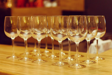 Wine glasses in row on bar