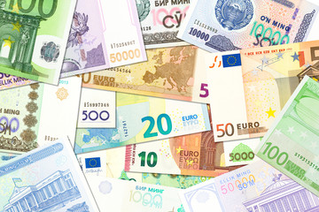 some Uzbek Som banknotes and Euro banknotes mixed indicating bilateral economic relations