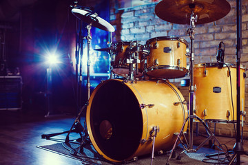 Modern drum set shot in smoky dark studio