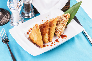 Uzbek cuisine, Central Asian dish. Tandoor samsa-layered dough, pieces of beef, onions, fat tail, baked in the tandoor-Uzbek national clay oven